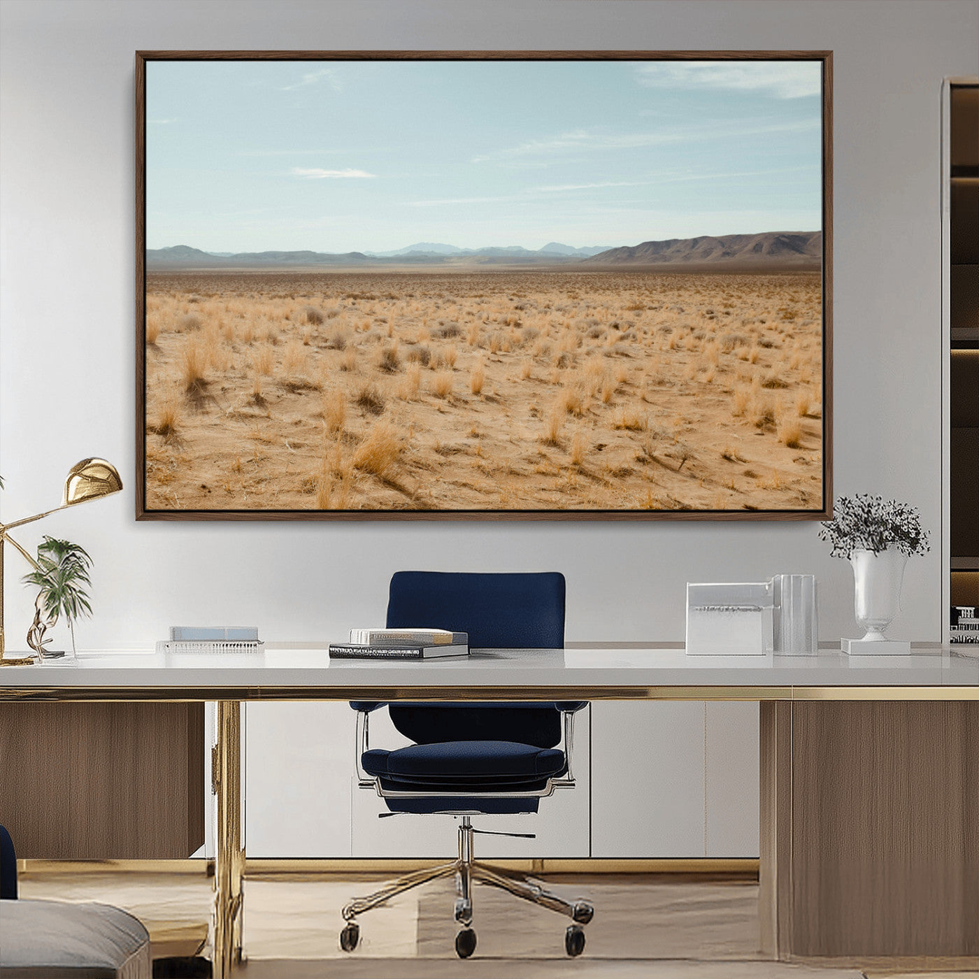Expansive desert landscape with scattered dry grass and distant mountain range under a pale blue sky – Wall Art Canvas Print.
