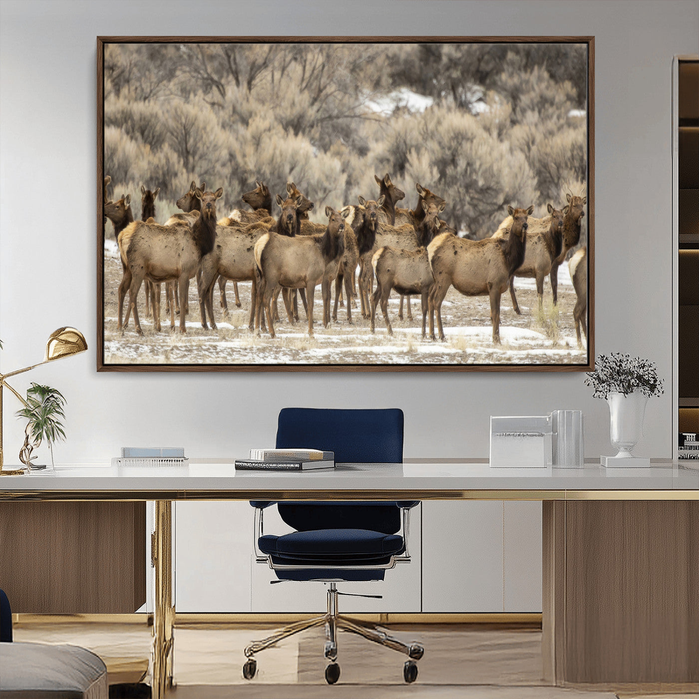 A stunning wall art canvas print featuring a large herd of elk standing together in a natural winter landscape with muted earthy tones and soft background foliage, perfect for rustic or nature-inspired home decor.