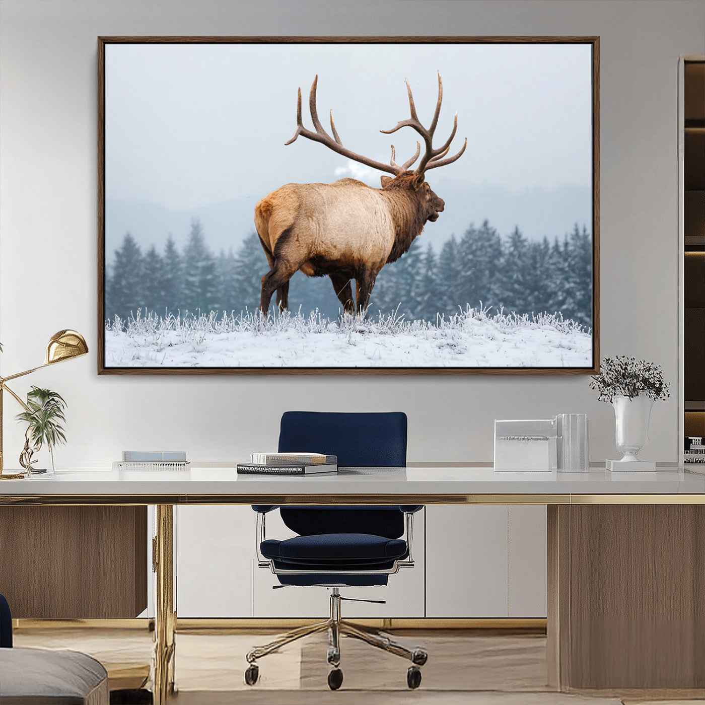 A majestic elk standing in a snowy landscape, with large antlers, set against a backdrop of evergreen trees and a soft winter sky.