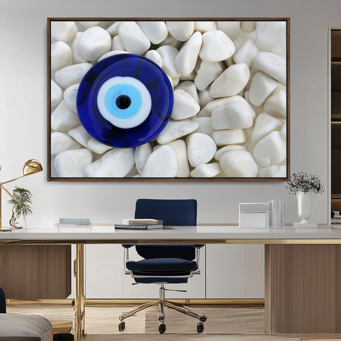 A close-up of a blue evil eye charm placed on white pebbles, symbolizing protection and good luck.