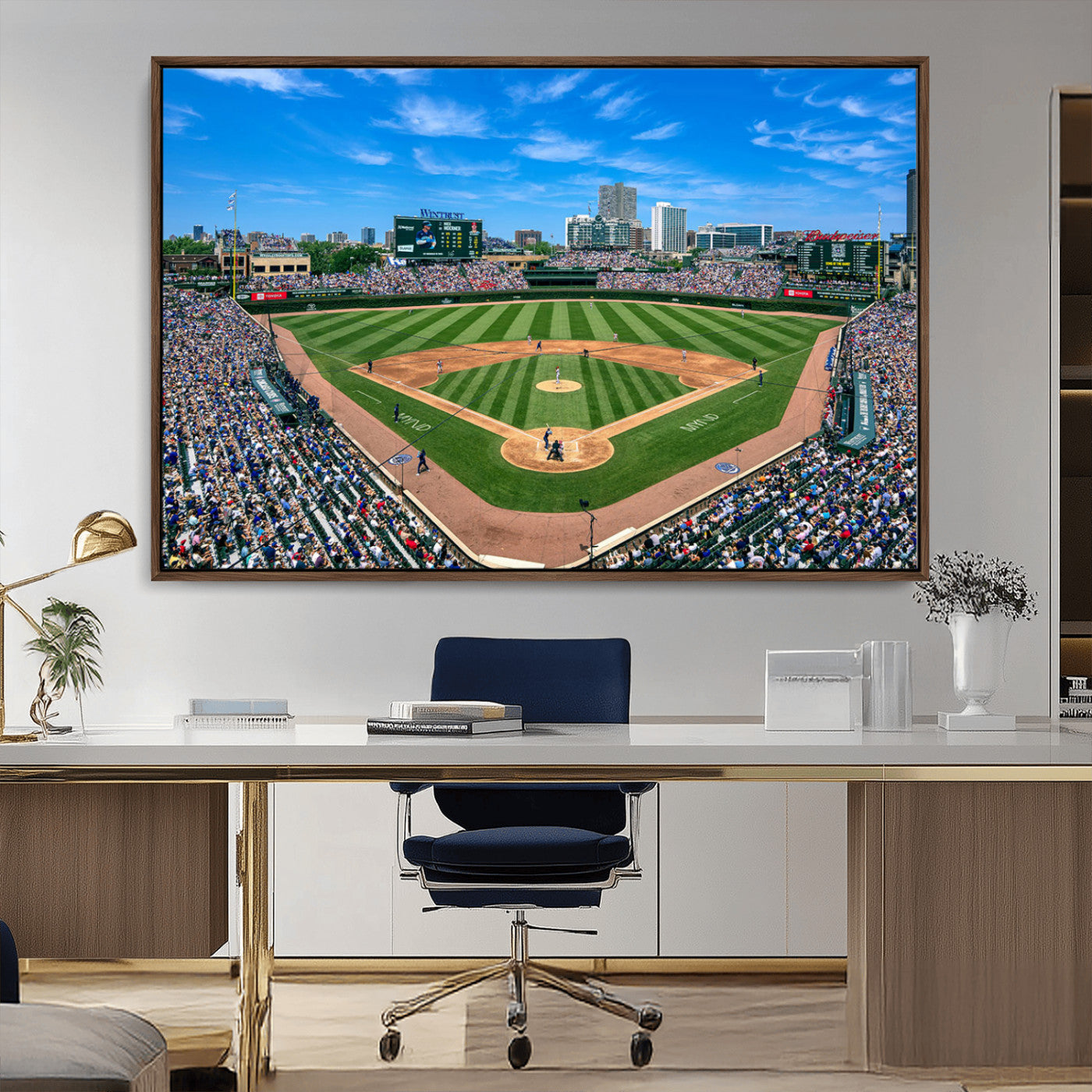 A wide-angle shot of a baseball field filled with spectators, with players on the field and the iconic Wrigley Field scoreboard in the background.