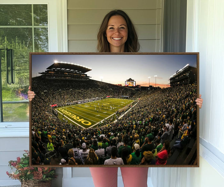 The Oregon Stadium Canvas Wall Art features a depiction of a packed Autzen Stadium with OREGON prominently displayed on the field.