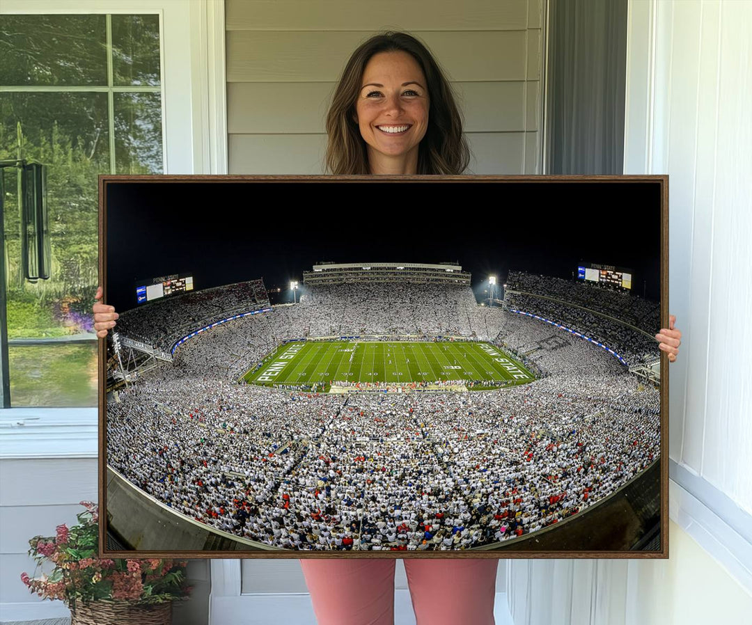 The triple canvas wall art depicts Beaver Stadiums vibrant atmosphere during a night game from the end zone.