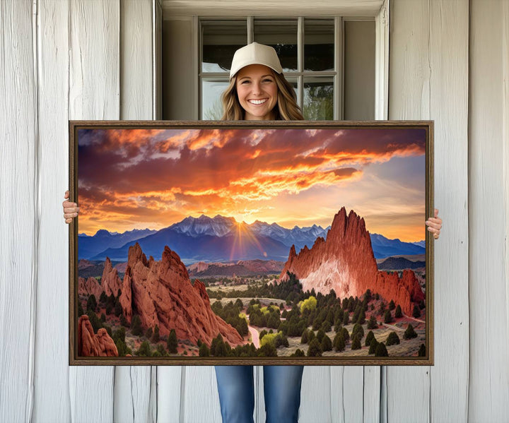 A vibrant sunset over the Rocky Mountains with red rocks.