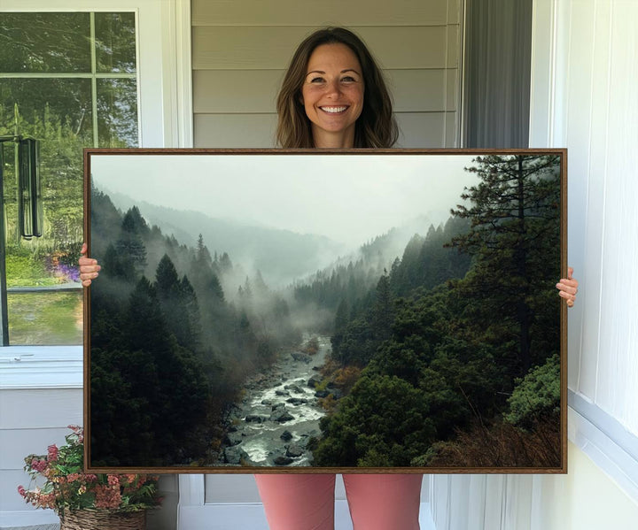 The Misty Forest Wall Art features a serene landscape with a misty river and evergreens, ideal for enhancing the ambiance of any living room or cabin.