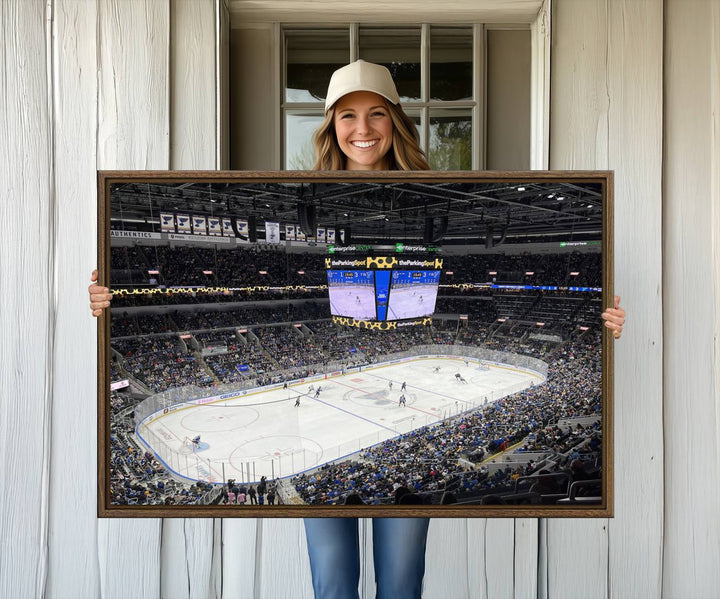 A large Enterprise Center canvas of a crowded hockey arena hangs prominently.