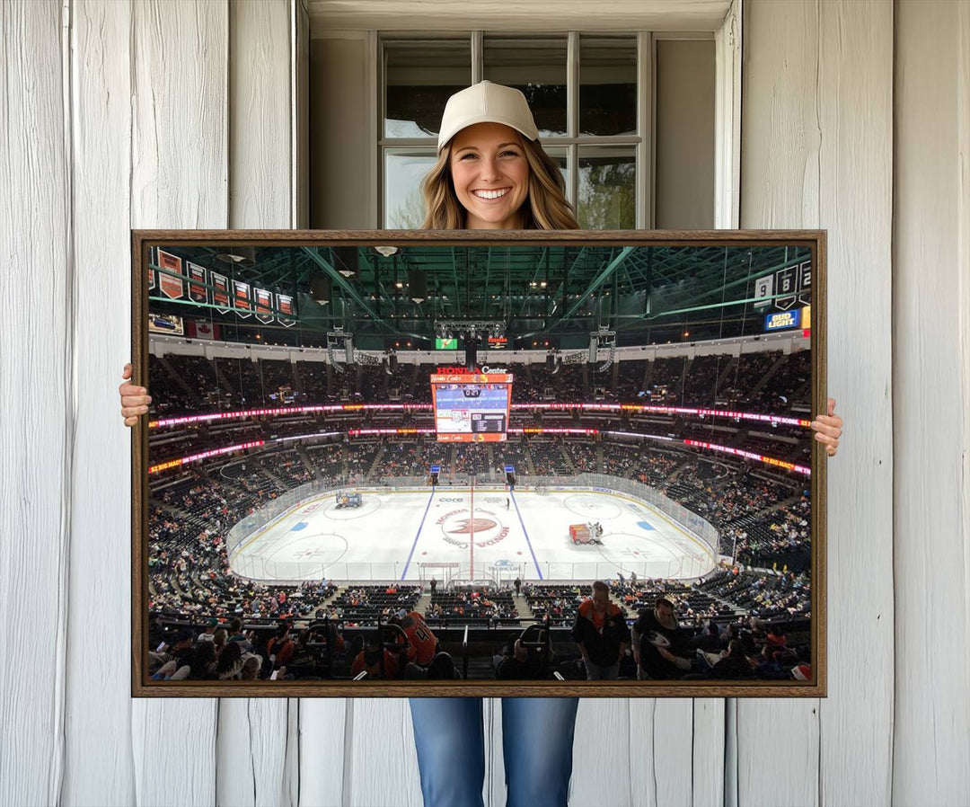 The wall art of the Honda Center California Anaheim Ducks Ice Hockey Stadium features a depiction of the rink and scoreboard from the perspective of the upper deck.