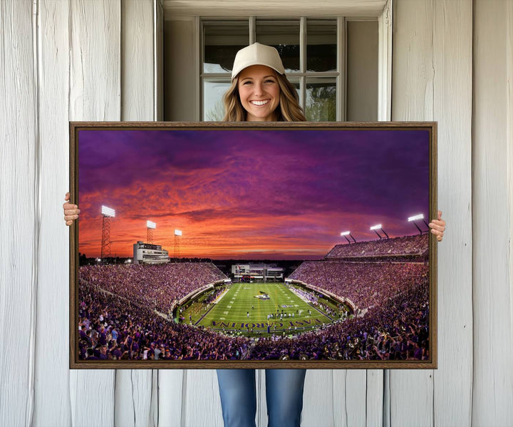 A sunset over Dowdy-Ficklen Stadium, Greenville, captured on museum quality canvas with vibrant purple and orange skies.