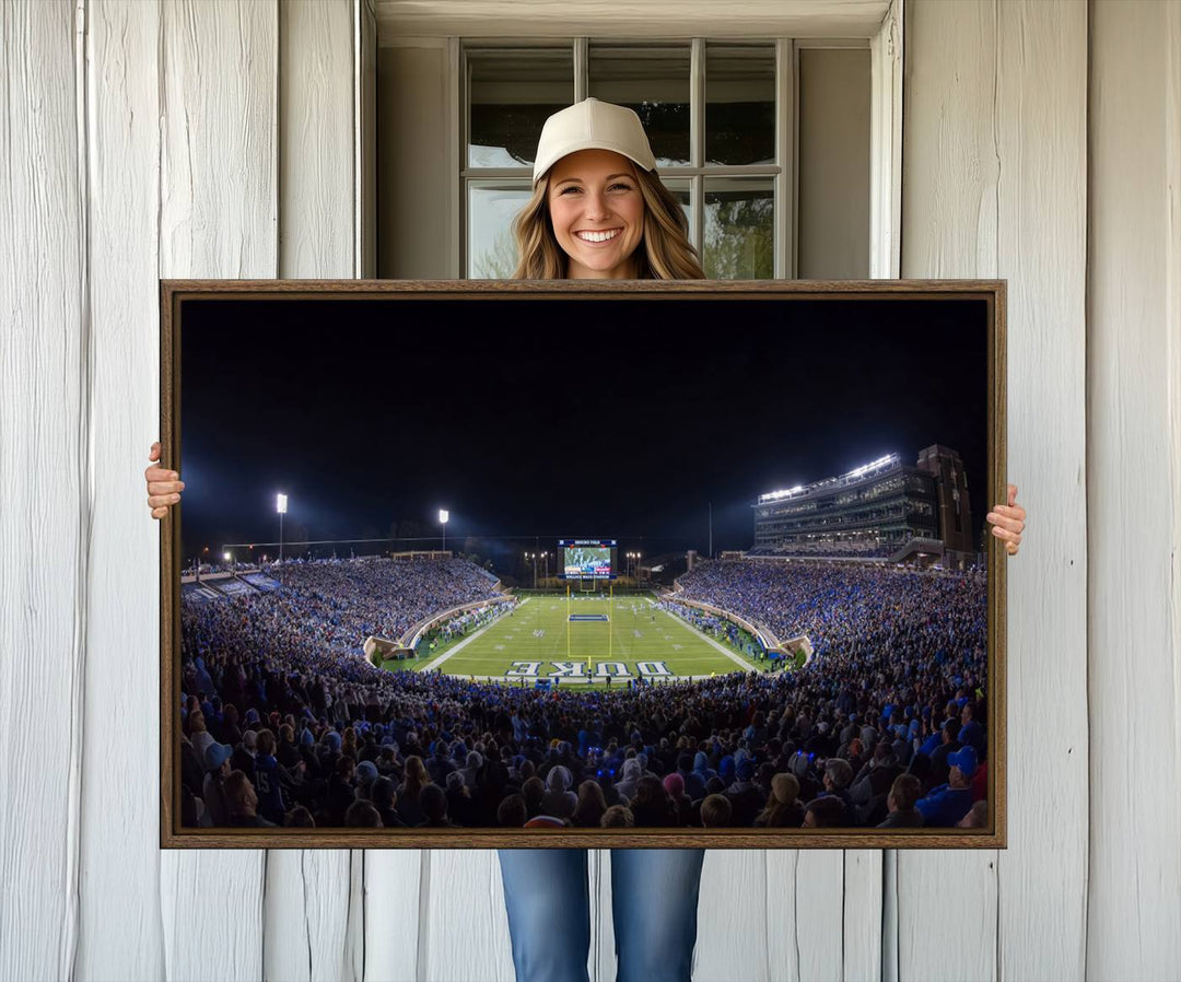 Under bright lights at night, the Duke Blue Devils Football Team Durham canvas wall art print is prominently displayed.