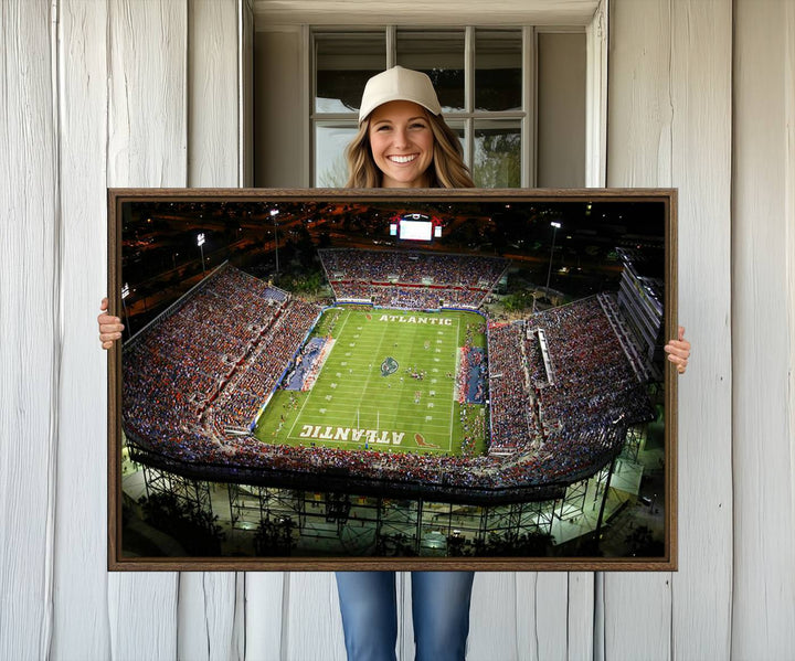 Gallery-quality wall art complements the view of the FAU Stadium with Florida Atlantic University Owls on the field in a night aerial setting.