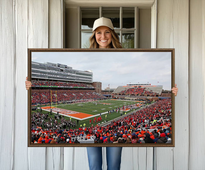 A University of Illinois Fighting Illini wall art canvas hangs on the wall, depicting a packed stadium.