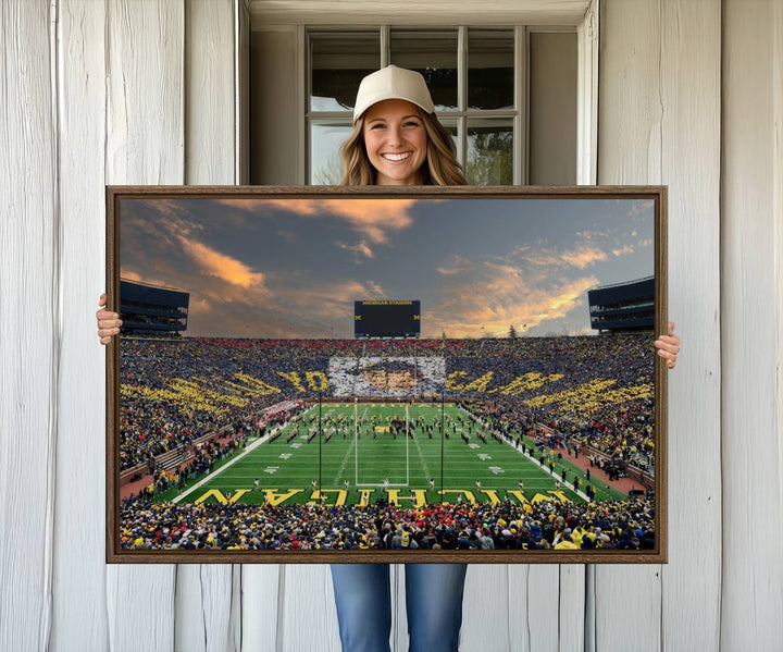 A giant image resembling Michigan Wolverines Wall Art depicts a football field beneath a dramatic sky.