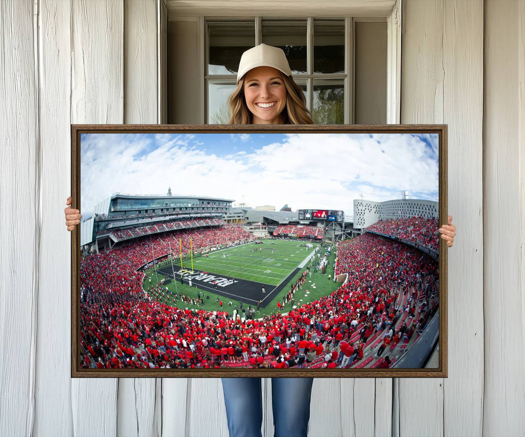 The wall showcases a Nippert Stadium canvas print of the Cincinnati Bearcats.