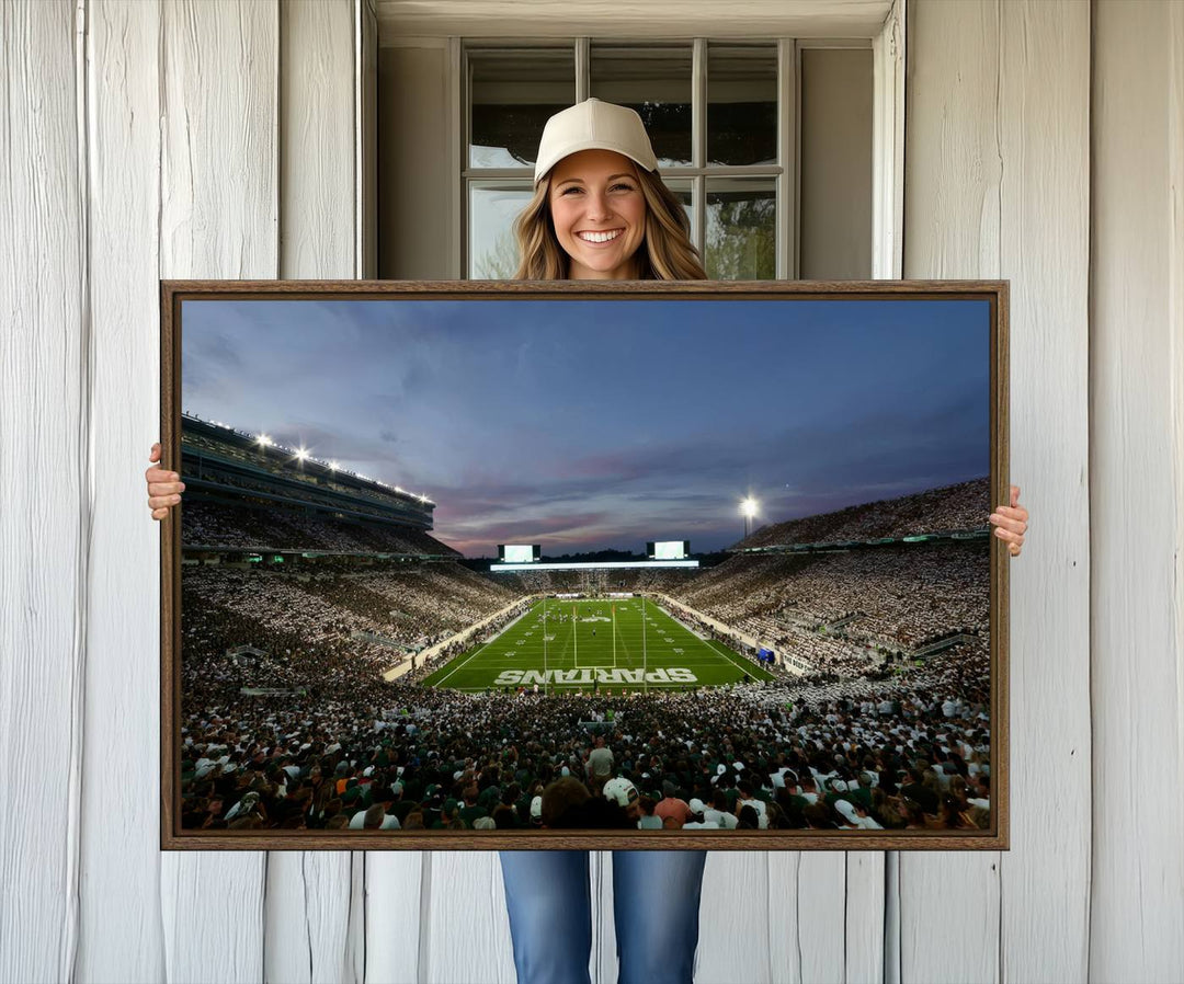 Wall art featuring a stadium at dusk with full stands—ideal for the Michigan State Spartans Football Team Canvas Print.