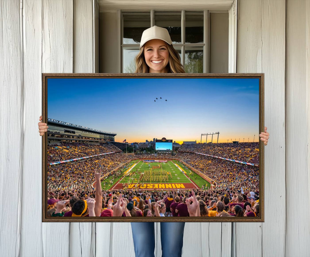 Canvas wall art featuring the University of Minnesota Football Team print, showcasing Huntington Bank Stadium at sunset with jets overhead.