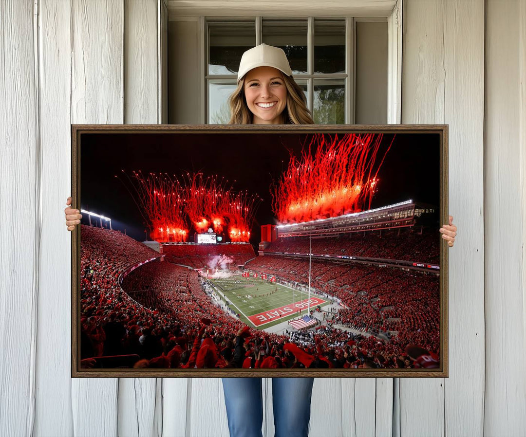 A vibrant red canvas art of a packed Ohio State Buckeyes stadium at night with fireworks.