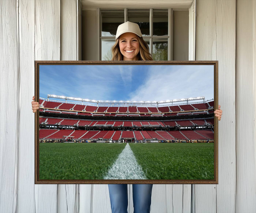 A canvas print of the University of Tulsa Golden Hurricane showcases H.A. Chapman Stadiums football field and red seats against a backdrop of a blue sky.