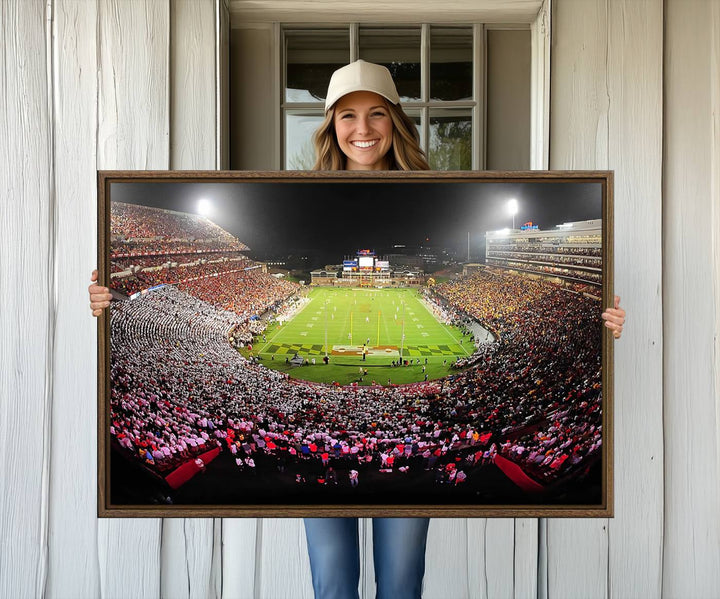 The Maryland Terrapins Football Wall Art Canvas showcases a packed SECU Stadium at night with a bright field and cheering fans.