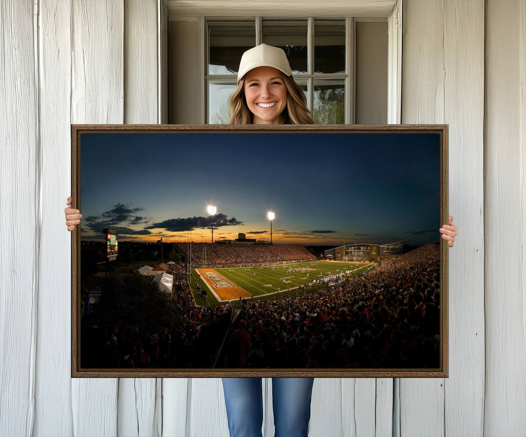 Ball State Cardinals Football Team Print - Muncie Scheumann Stadium Canvas featuring a sunset, floodlights, and lively crowd.