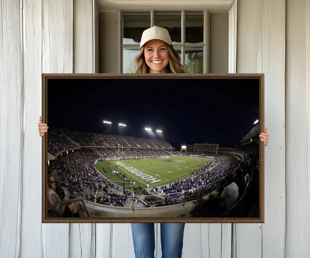 The wall art print features a night view of Amon G. Carter Stadium filled with TCU fans, showcased in the Horned Frogs Football Canvas Wall Art.