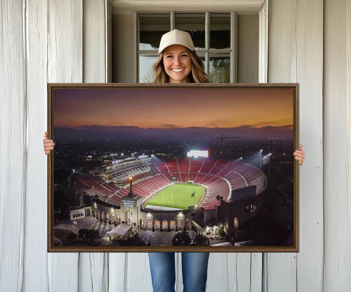 The USC Trojans Stadium canvas captures Memorial Coliseum at twilight, showcasing red seats and a green field beneath an orange sky.