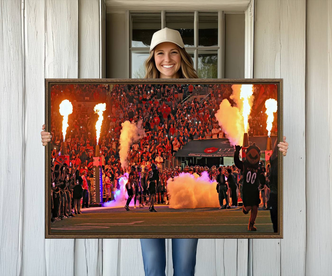 This canvas print captures the UTSA Roadrunners storming the Alamodome under smoke and fire.