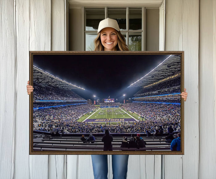 A canvas print titled The University of Washington Huskies Football depicts a packed Husky Stadium at night, as seen from the stands.