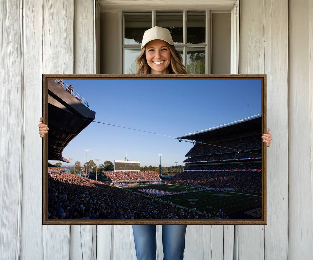 The University of Washington Huskies wall art print depicts Husky Stadium coming alive with fans as flags flutter.