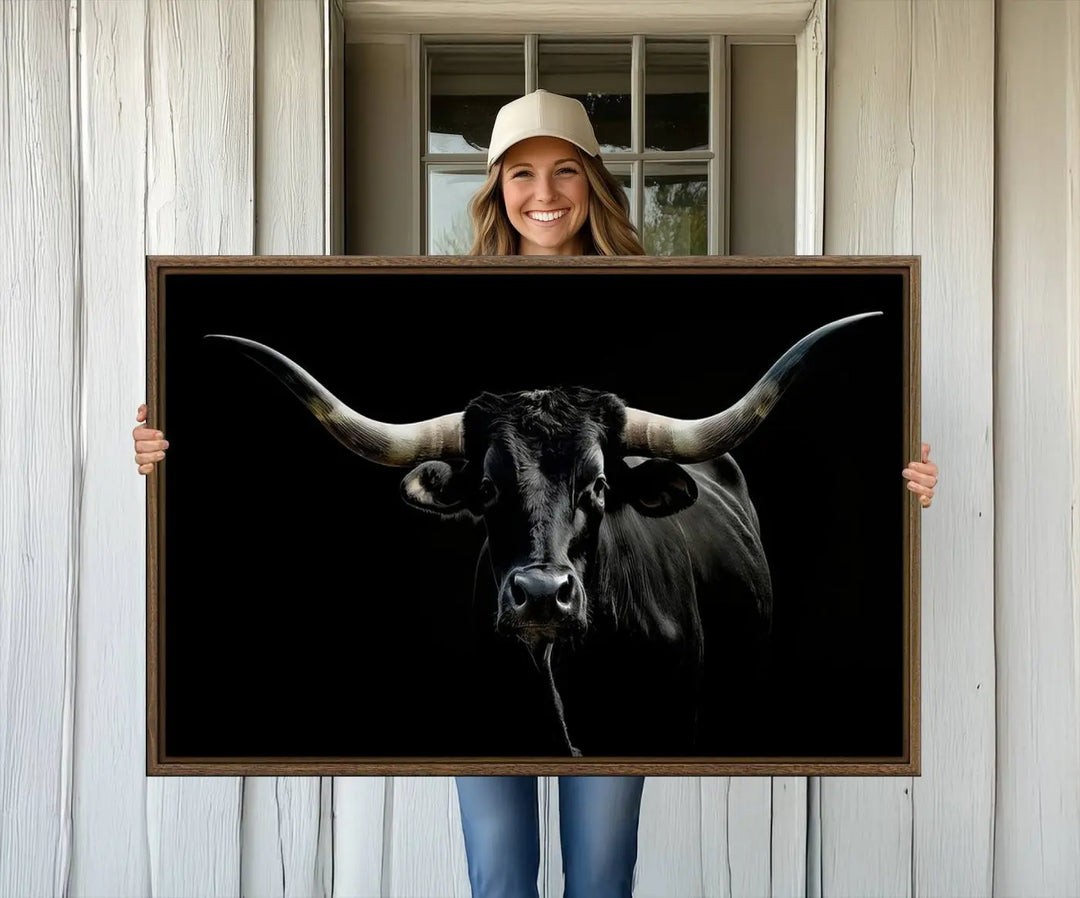 A captivating close-up canvas print of a Texas Black Longhorn with impressive curved horns set against a dark backdrop, ideal as a standout piece in your collection of Longhorn Cow Wall Art.