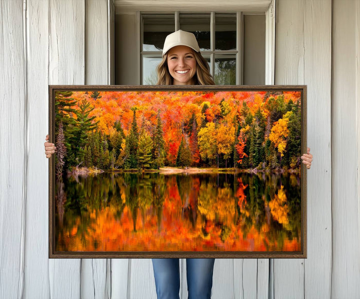 Autumn Forest Reflection Wall Art: a vibrant triptych canvas featuring fall foliage with red, orange, and yellow leaves over a calm lake.