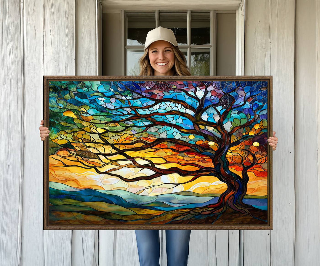 A vivid Tree of Life in stained glass style is depicted with twisted branches, a colorful sky, and hills on a ready-to-hang canvas.