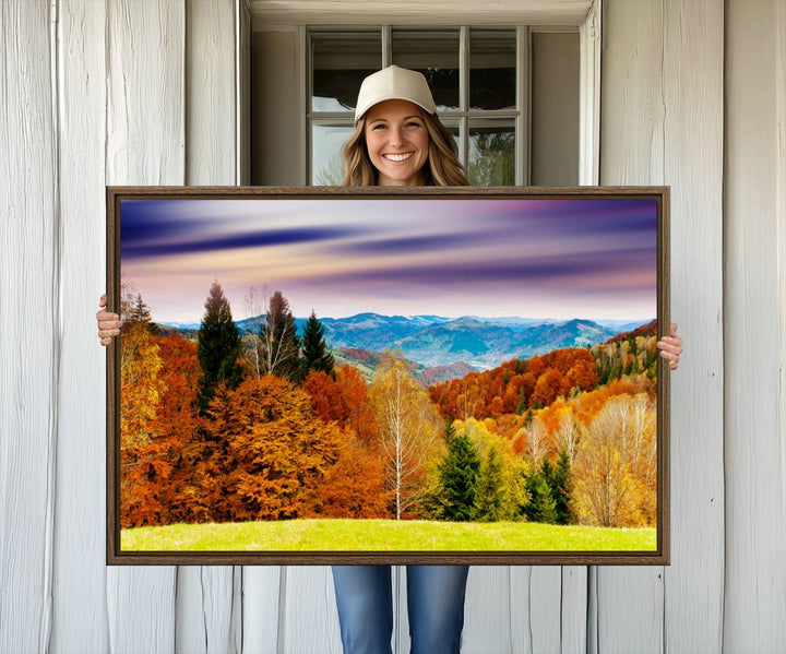 The wall art in the kitchen dining area is a large Autumn Forest Mountain Canvas Print that captures a vivid scenic landscape.