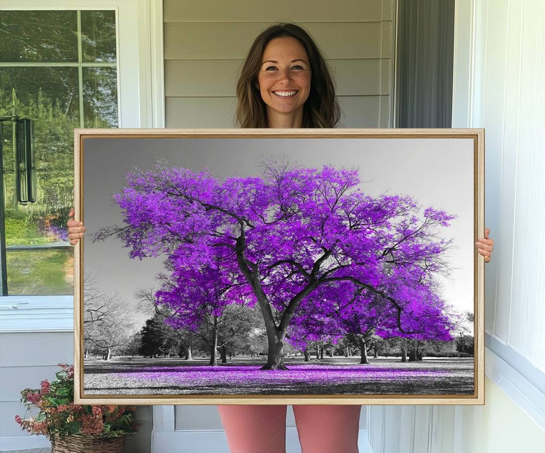 The Big Purple Tree Wall Art Canvas Print showcases a vibrant purple tree set against a black-and-white landscape.