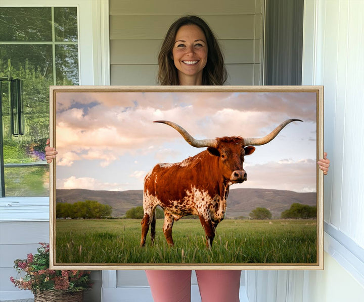 The Texas Cow Canvas Wall Art print captures a longhorn cow at sunset and is ready to hang.