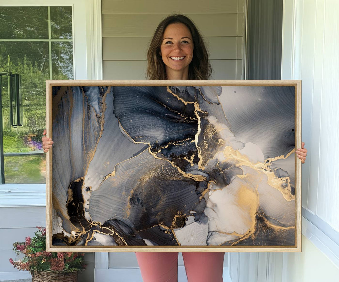 A Modern Marble Fluid Effect Abstract Wall Art with black, white, and gold swirls hangs in a modern kitchen.