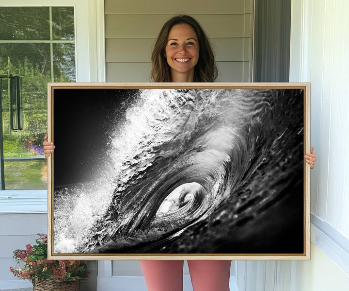 The Black Ocean Wave at Sunset Canvas Art hangs on a grey wooden wall.