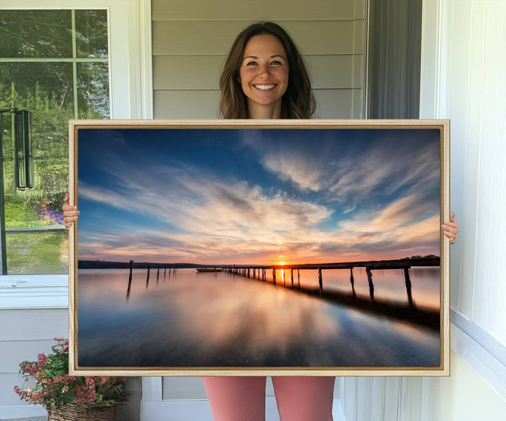 The Sunset Pier Canvas features a serene coastal landscape with vibrant hues under cloudy skies, ideal for modern decor.