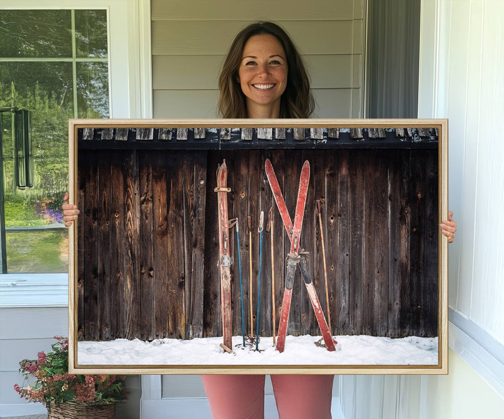 A canvas print titled Vintage Ski Gear Against Wooden Cabin Wall adorns the wall.