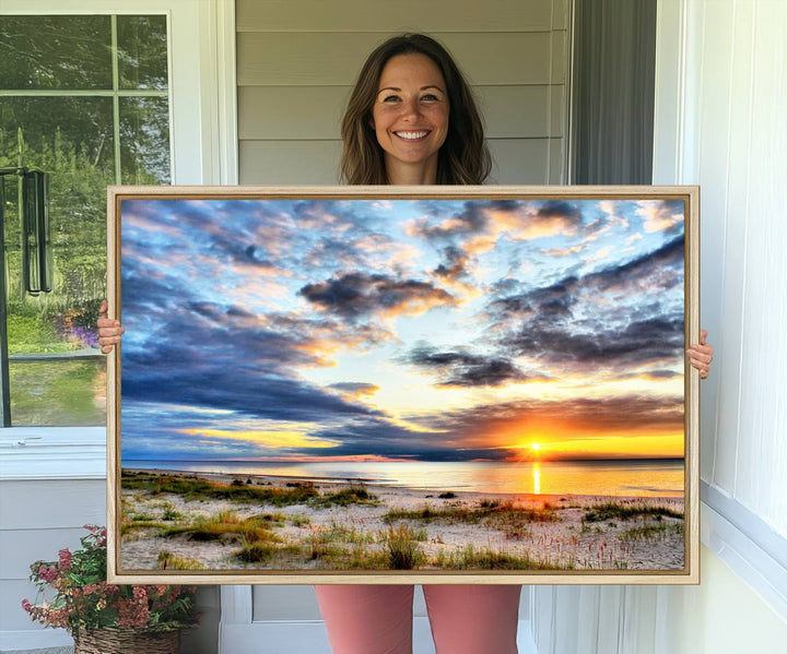 The Sunset On The Ocean canvas wall art features a beautiful beach sunset with grass and clouds.