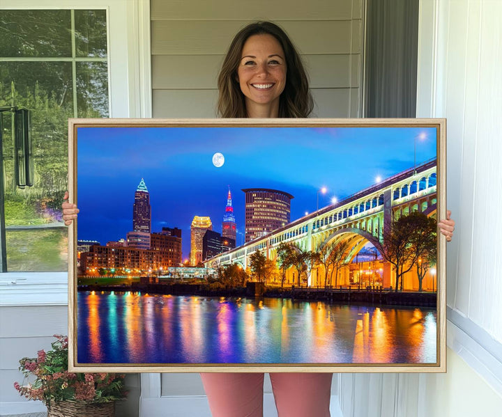 A Cleveland Night Skyline Wall Art on museum-quality canvas showcases a bridge and illuminated buildings.