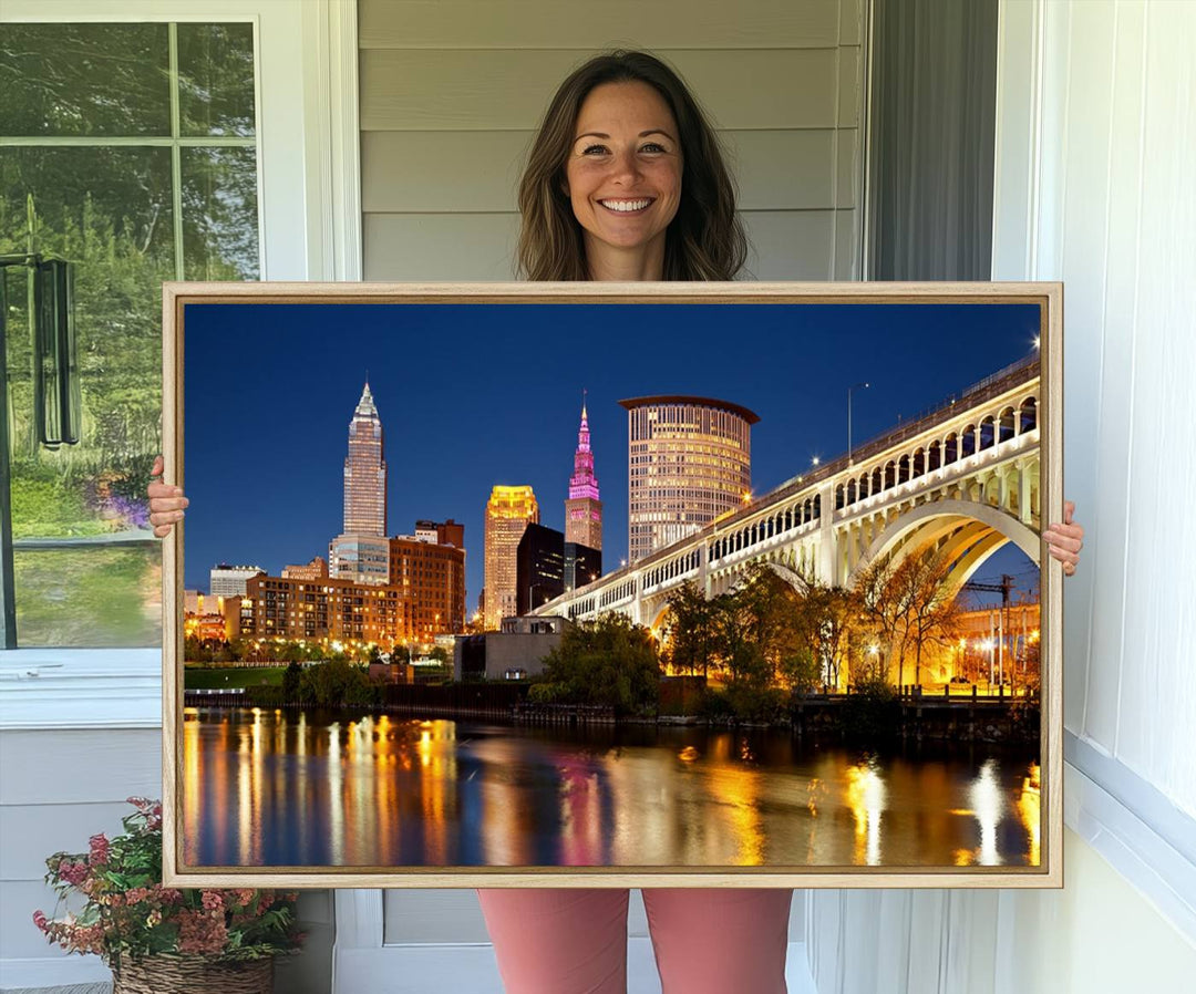 The Cleveland City Lights Canvas showcases a lit-up bridge and cityscape at night.