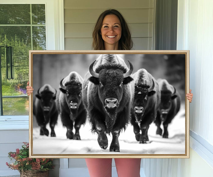 A black and white American Bison herd canvas print adorns the wall.