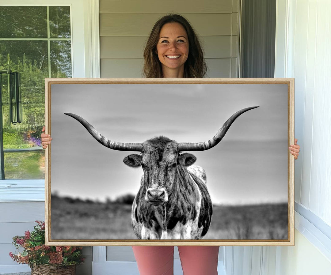 The Texas Longhorn Cow wall art, divided into three panels, is of gallery quality and displayed on a dark wall.