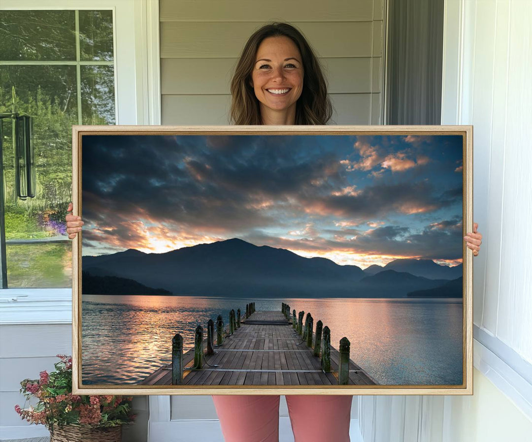 The Mountain Lake Wood Pier Canvas Wall Art depicts a serene lake and mountains, enhancing the beauty of any space.