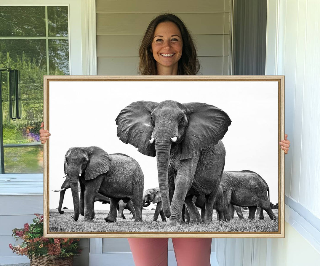 A modern dining area features a Black White Elephant Family Wall Art Canvas Print.