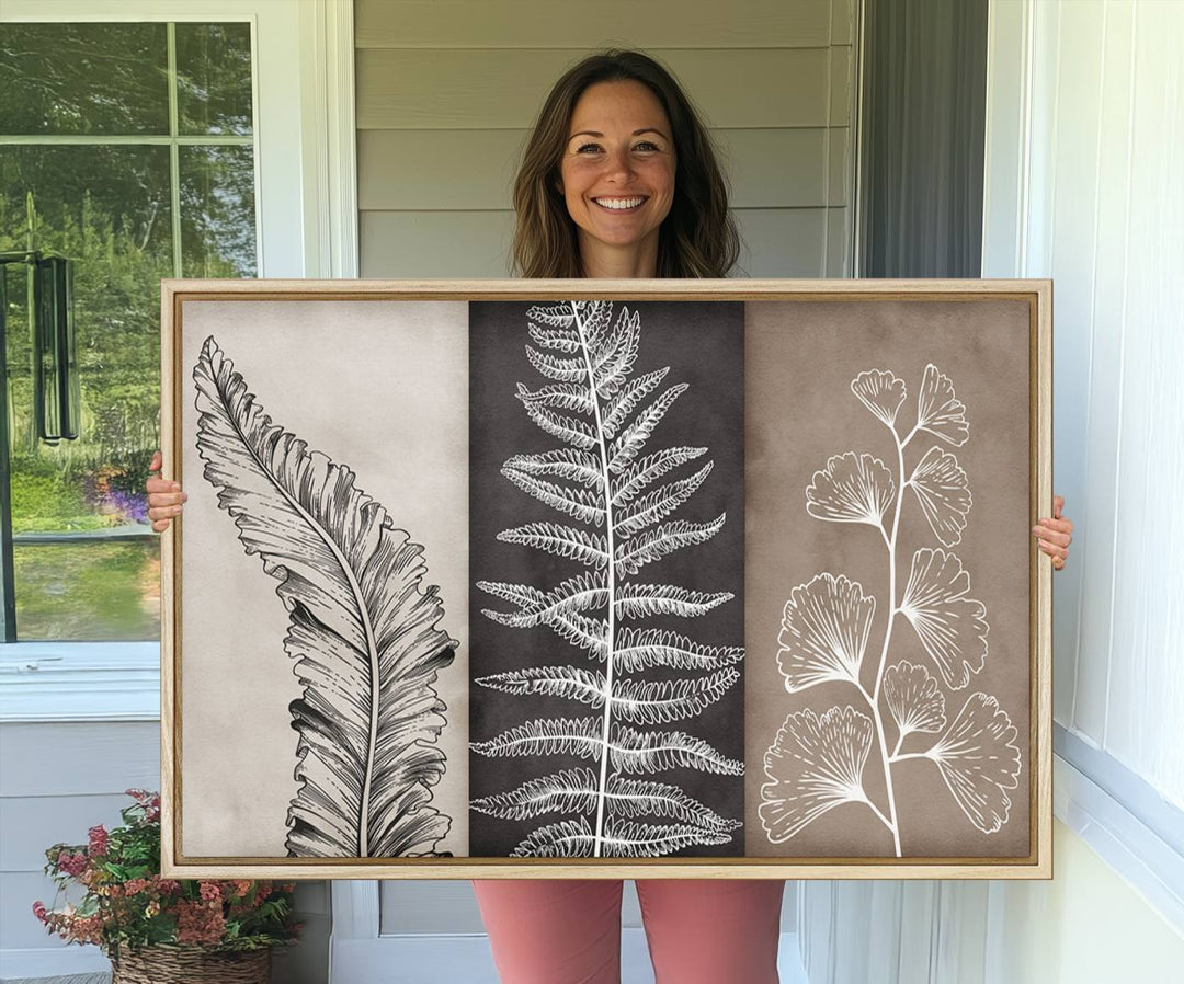 Three framed botanical wall art pieces are displayed in a bright room.