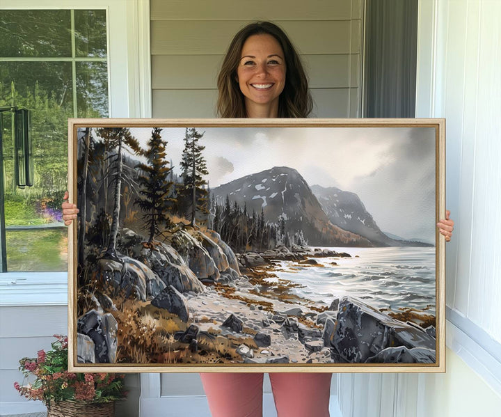 Framed wall art depicting Acadia National Parks rocky coast, trees, mountains, and sunlight over the sea; ready to hang.