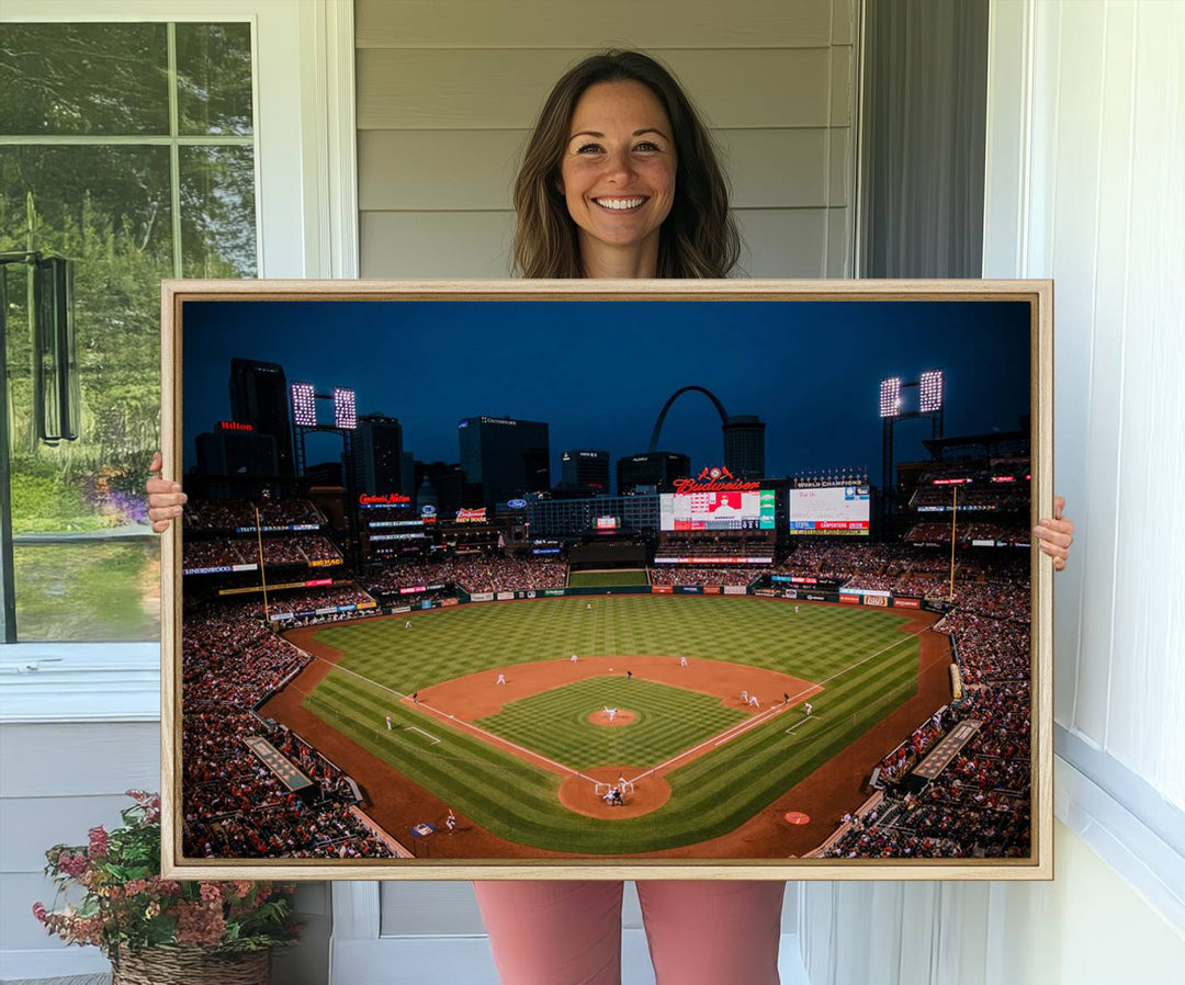 A St. Louis Cardinals Baseball Team print of Busch Stadium at night adorns the wall.