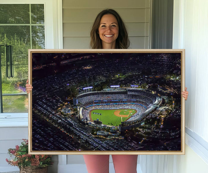 A large Los Angeles Dodgers print of Dodger Stadium at night is displayed near a window.