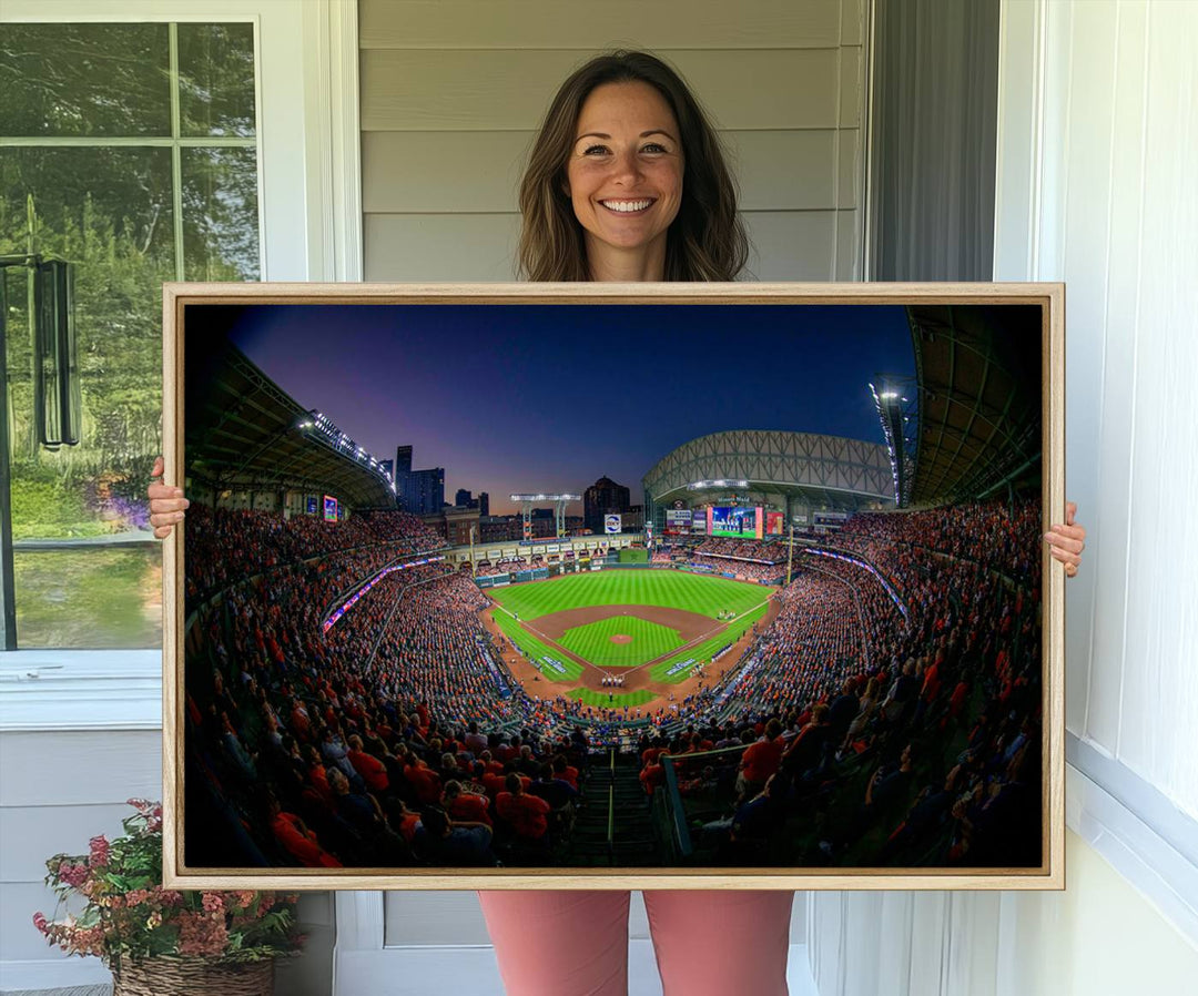 A canvas print of Houston Minute Maid Park at dusk is mounted on the wall.